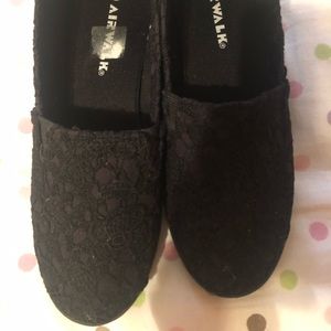Flat black air walk shoes.